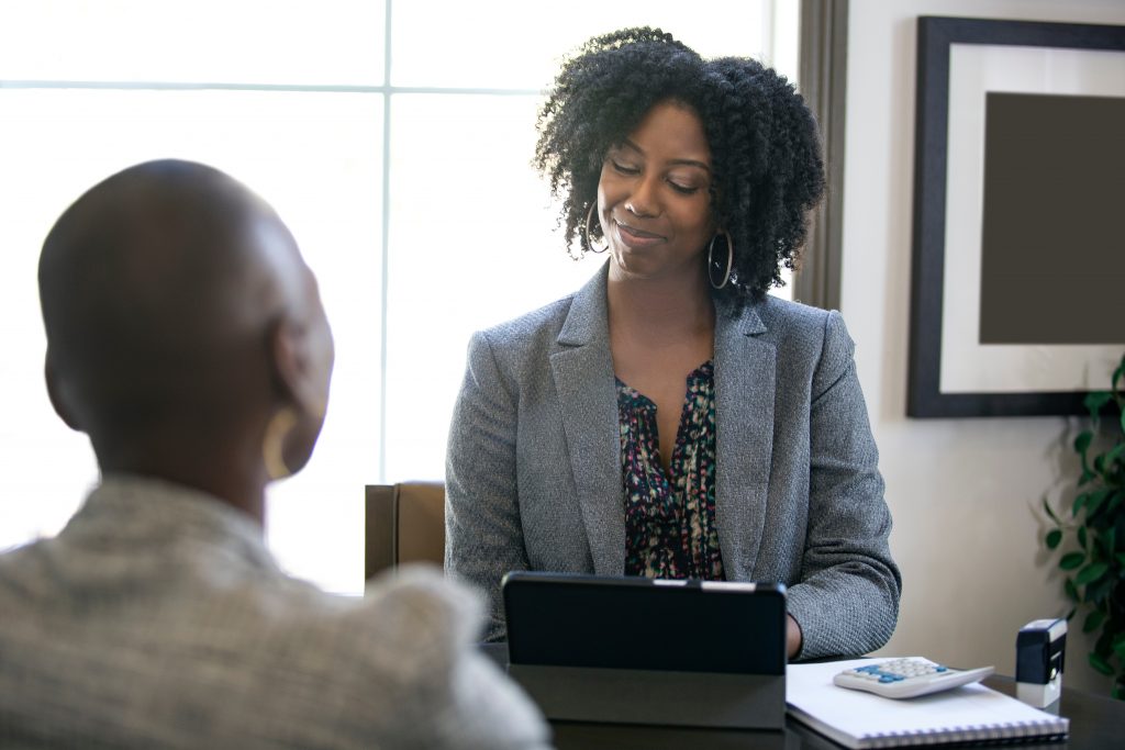 Two women sitting at a desk during a performance review